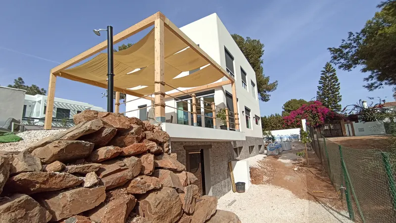 Wooden Pergola with Shade Sail & Rockery Wall
