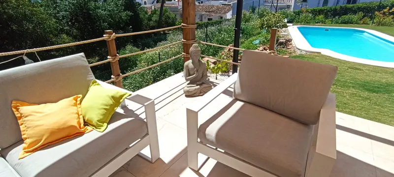 Lounge Area with Rattan Armchairs & Buddha Accent